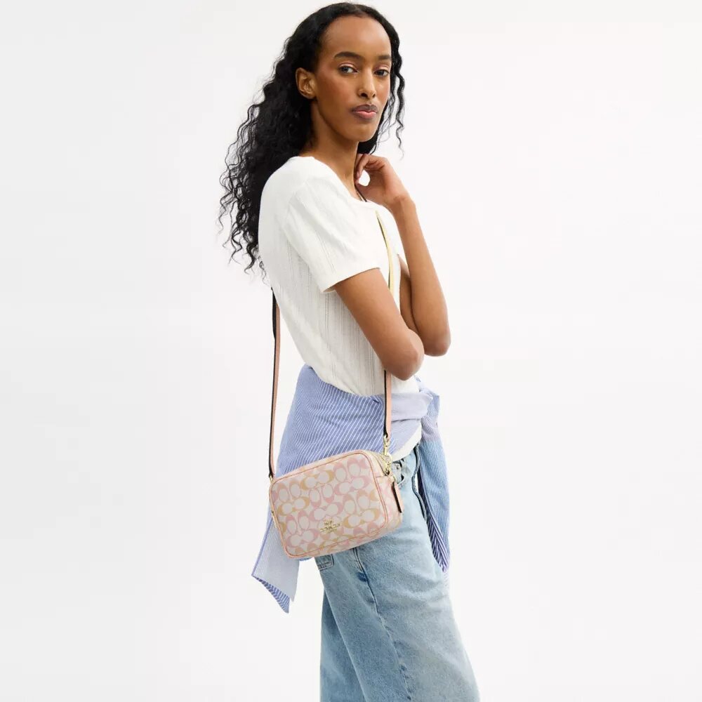 Bolso mini Carey de bandolera en Signature Canvas