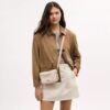Bolso mini Carey de bandolera en Signature Canvas