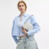 Bolso mini Carey de bandolera en Signature Canvas