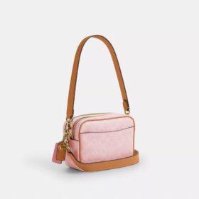 Bolso mini Carey de bandolera en Signature Canvas con Charms