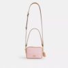 Bolso mini Carey de bandolera en Signature Canvas con Charms