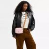 Bolso mini Carey de bandolera en Signature Canvas con Charms