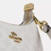 Bolso mini cruzado Teri en Signature Canvas