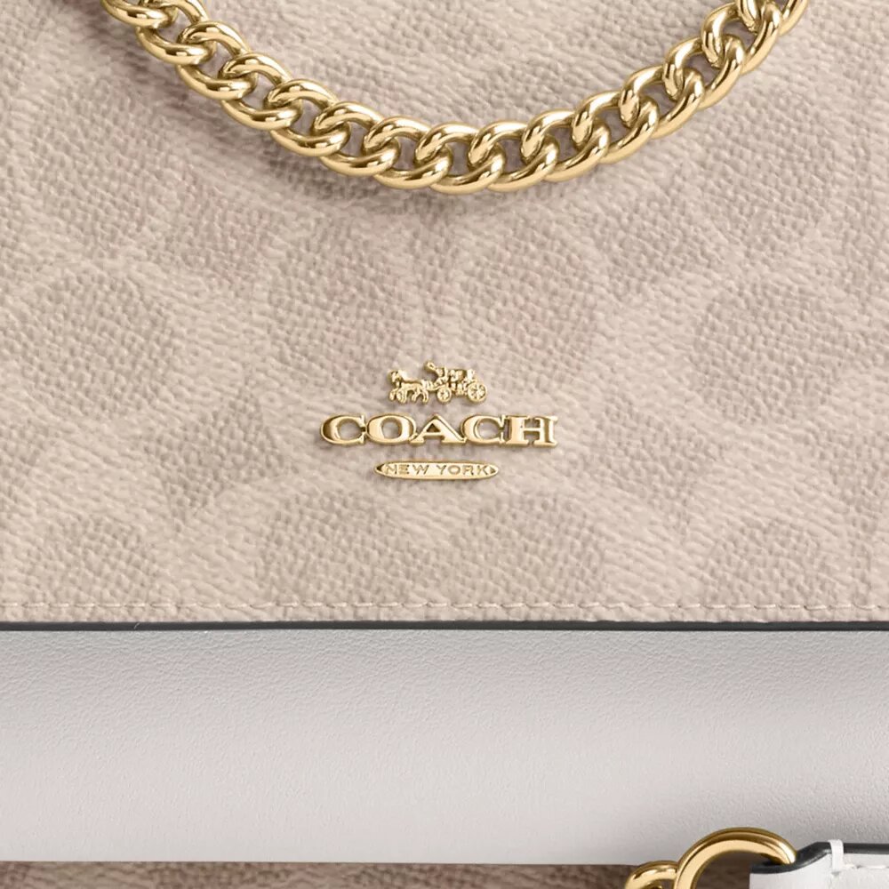 Bolso mini Klare de bandolera en Signature Canvas