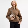Bolso mini Klare de bandolera en Signature Canvas