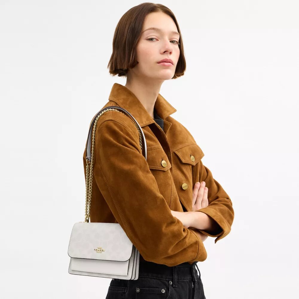 Bolso mini Klare de bandolera en Signature Canvas
