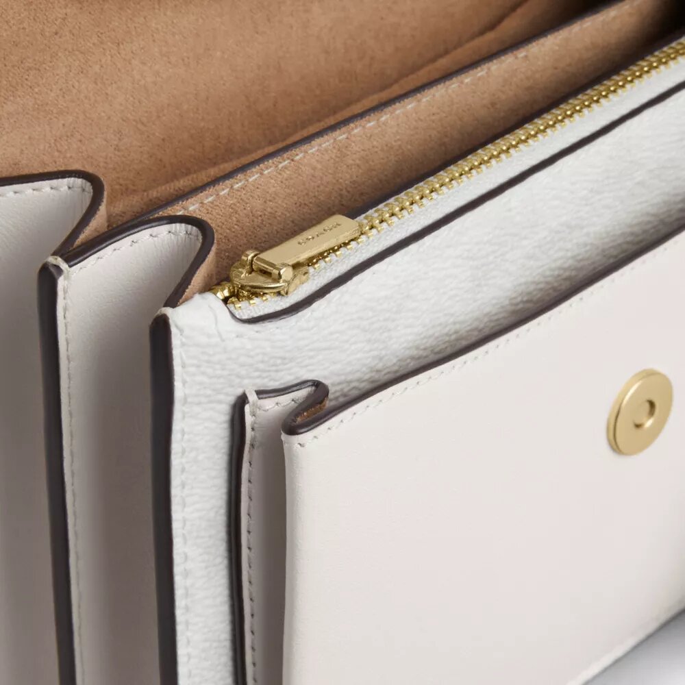 Bolso mini Klare de bandolera en Signature Canvas