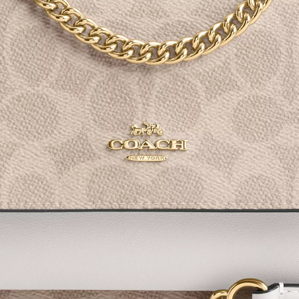 Bolso mini Klare de bandolera en Signature Canvas