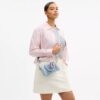 Bolso mini Rowan de bandolera en denim desgastado con Charms