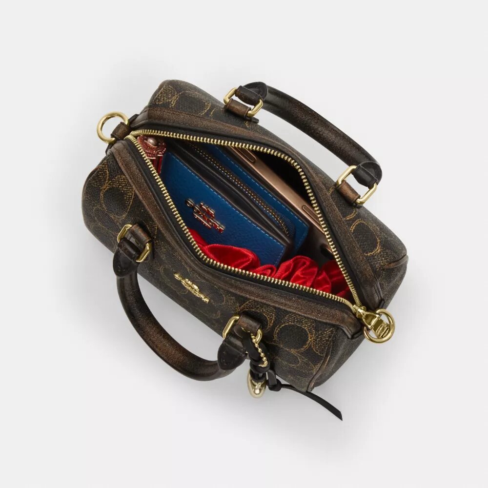 Bolso mini Rowan de bandolera en Signature Canvas con Charms