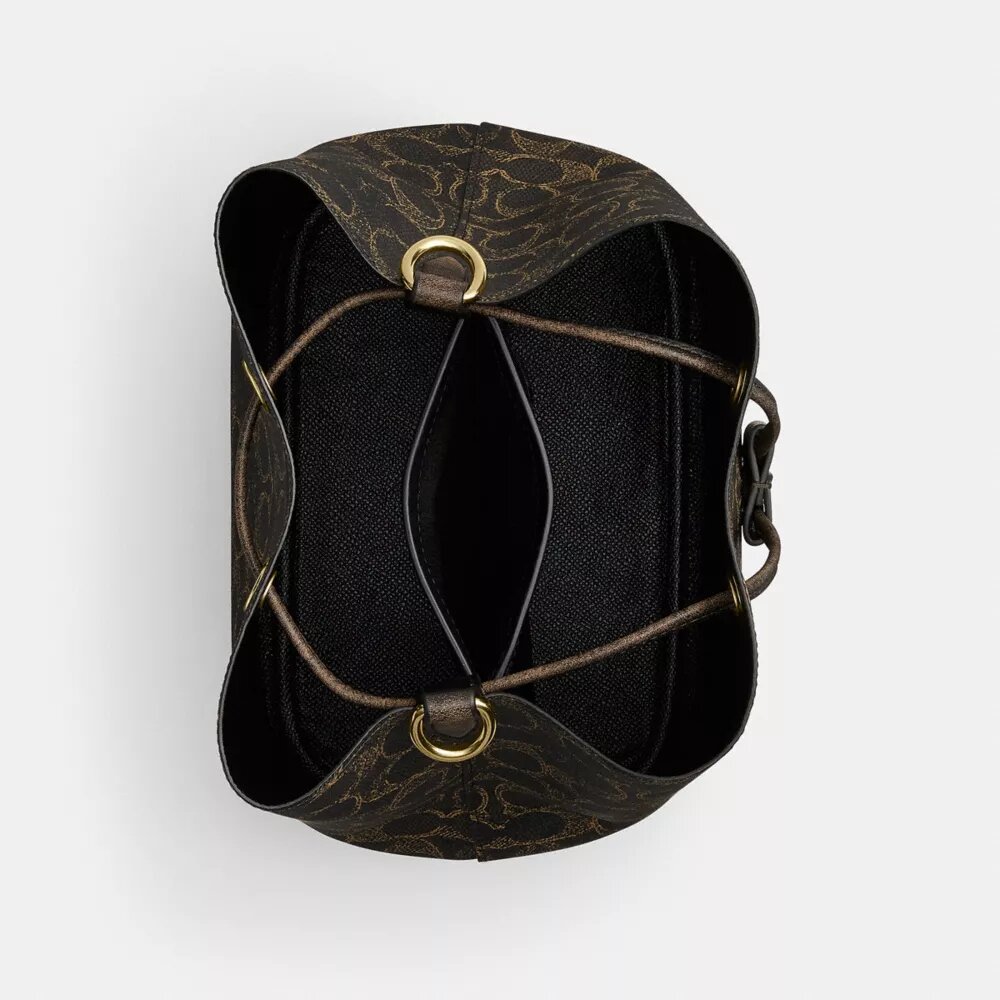 Bolso tipo cubeta Rowan en Signature Canvas con Charms