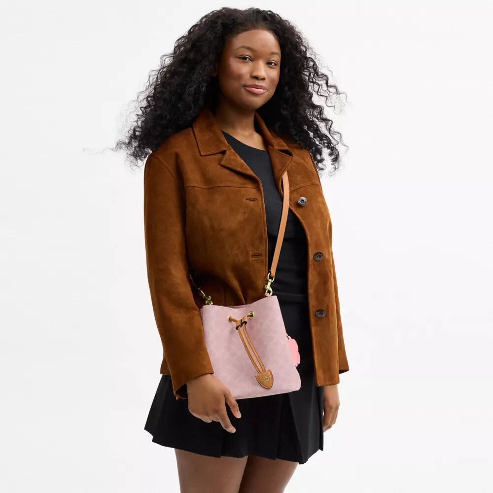 Bolso tipo cubeta Rowan en Signature Canvas con Charms