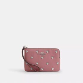 Bolsos de pulsera con cremallera en la esquina y remaches en forma de corazón