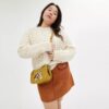 Bolsos Swinger de Disney x Coach en cuero regenerativo con Mickey Mouse y sus amigos