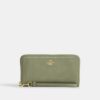 Cartera larga con cremallera alrededor y acolchado