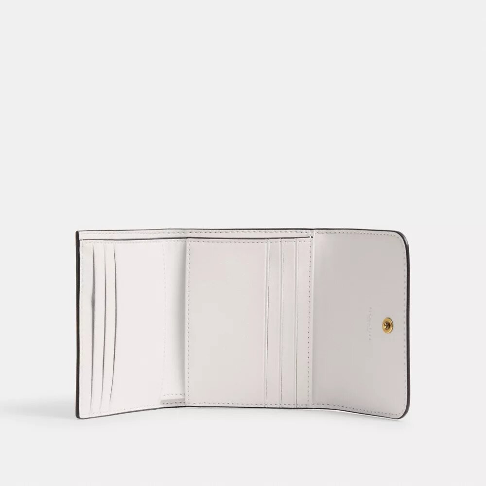 Cartera pequeña con solapa Mila y estampado de calcomanías