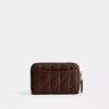 Cartera pequeña esencial con cierre de cremallera y acolchado tipo almohada