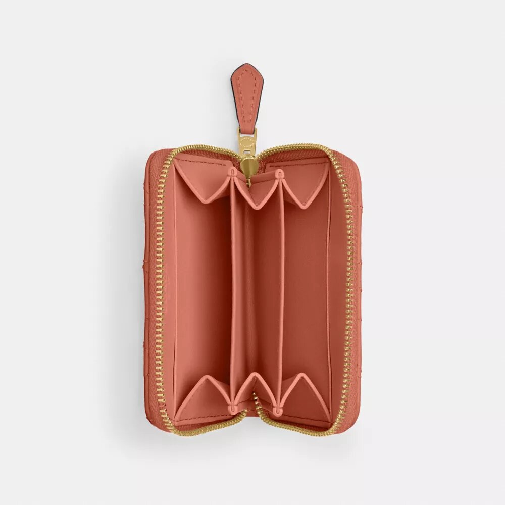 Cartera pequeña esencial con cierre de cremallera y acolchado tipo almohada