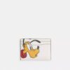 Portatarjetas Essential de Disney X Coach con Pluto