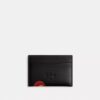Portatarjetas Essential de Disney X Coach con Pluto